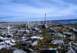 Eskimo cemetery on high ground overlooking the buildings and homes in Igloolik.