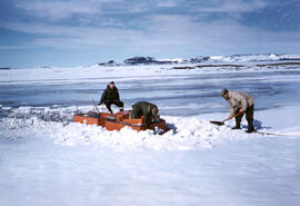 Trying to pull the stuck machine up a slight bank. St Onge and Moskal with another scientist.