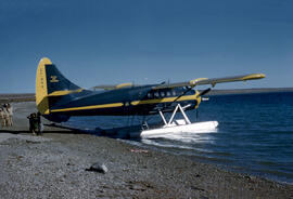 RCMP Otter aircraft visiting lgloolik, bringing in supplies and transporting, people. Same aircra...
